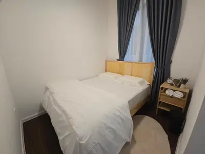 a small bedroom with a bed and a window at Kea Farm Stay in Brinchang