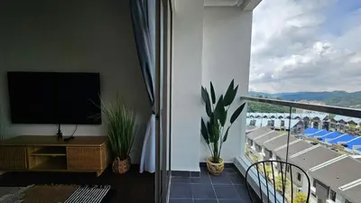a living room with a balcony with a flat screen tv at Kea Farm Stay in Brinchang