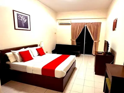 a bedroom with a bed with a red and white blanket at Suria Escape Bukit Merah in Simpang Ampat Semanggol