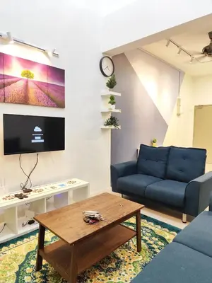 a living room with a blue couch and a coffee table at Bukit Urbane Night Market CH in Brinchang