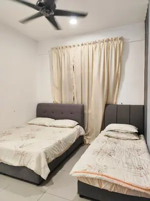 two beds in a room with a ceiling fan at Bukit Urbane Night Market CH in Brinchang