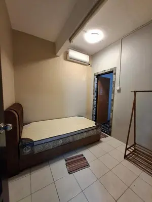 a room with a bed in the corner of a room at Family Homestay Bidor in Gua Sai