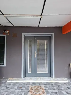 a gray door with a window on a building at Family Homestay Bidor in Gua Sai