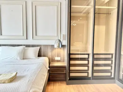 a bedroom with a bed and a glass wall at Tropicana 218 Macalister #LuxuryFrenchVintage #InfinityPool #Studio2pax #Quality well maintained #Private host in George Town
