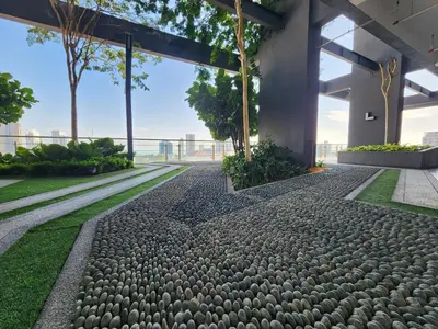 a walkway in a building with rocks and grass at Tropicana 218 Macalister #LuxuryFrenchVintage #InfinityPool #Studio2pax #Quality well maintained #Private host in George Town