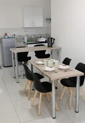 a kitchen with a table and chairs with plates and cups at Ipoh Homestay at Anderson - 2 Room 2 Bathroom -Maximum 6 pax --Self Check In-- in Ipoh