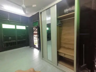 a room with sliding glass doors and a balcony at Teratak Taha in Kepala Batas