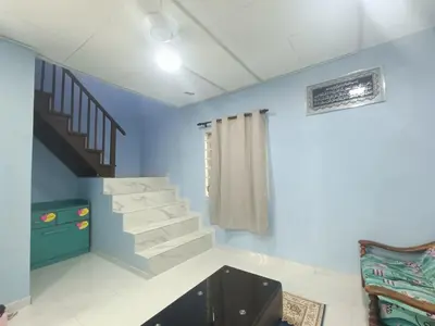 a room with blue walls and a stair case at Teratak Taha in Kepala Batas