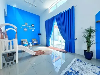 a baby room with a crib and blue walls at Santorini Vibes Penang - Tasek Gelugor in Kampong Selamat