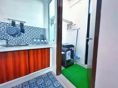 a bathroom with a sink and a green floor at Santorini Vibes Penang - Tasek Gelugor in Kampong Selamat