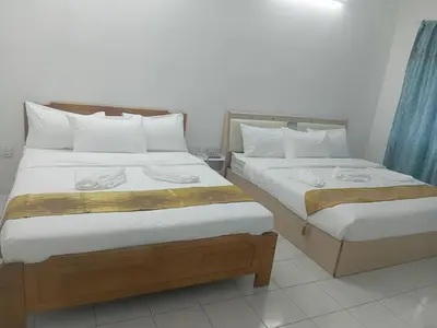 two beds sitting next to each other in a room at Olive home in Ipoh
