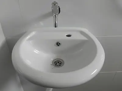 a white sink with a faucet in a bathroom at Olive home in Ipoh