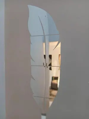 a mirror reflecting a living room with a couch at Olive home in Ipoh