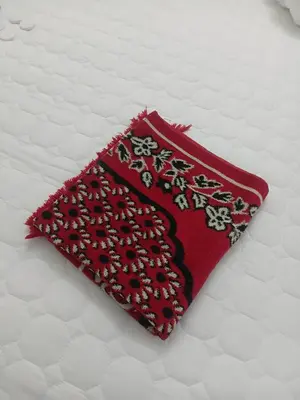 a red pillow sitting on top of a bed at Olive home in Ipoh