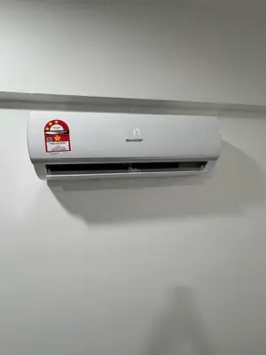 a monitor on a shelf with a white wall at Modern & Cozy Home Stay in Kampar