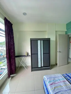 a bedroom with a bed and a window at SK Holiday Apartment in Tanah Rata