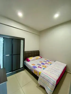 a bedroom with a bed and a window at SK Holiday Apartment in Tanah Rata