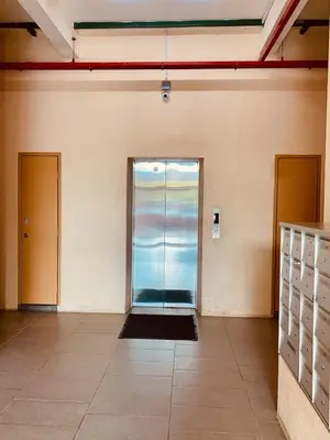 an empty room with a glass door in a building at SK Holiday Apartment in Tanah Rata