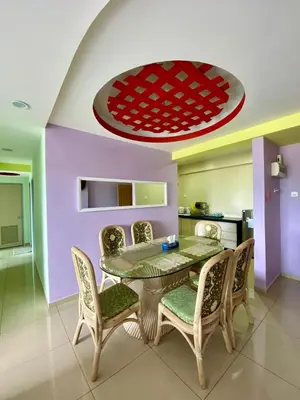 a dining room with a table and chairs at SK Holiday Apartment in Tanah Rata