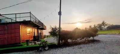a small house with the sun in the background at Casa Studio Roomstay Sekinchan in Sekincan