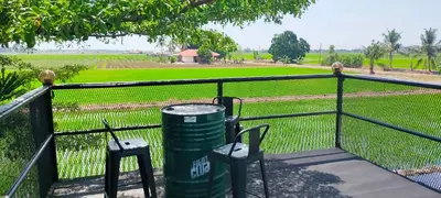 two chairs and a trash can next to a fence at Casa Studio Roomstay Sekinchan in Sekincan