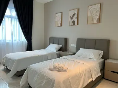 two beds in a hotel room with two wedding rings at Karaoke Cozy Landed Home at Sutera n Paradign for 10pax in Gua Sai