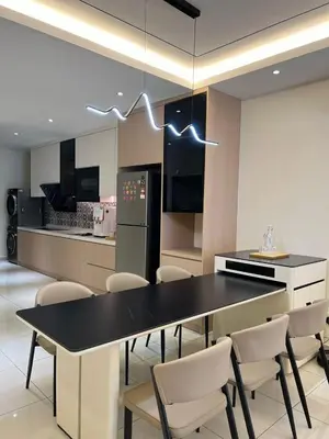a kitchen with a black table and white chairs at Karaoke Cozy Landed Home at Sutera n Paradign for 10pax in Gua Sai