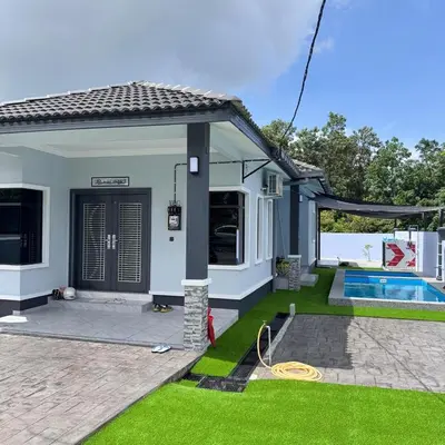 a house with a swimming pool and a yard at Homestay D'Ammar Private Pool in Gua Sai