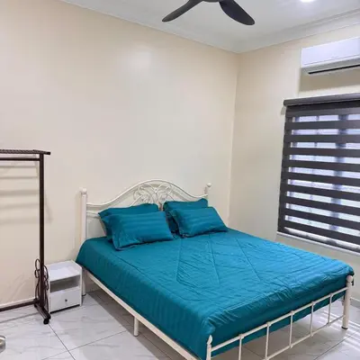 a bedroom with a bed with blue pillows at Homestay D'Ammar Private Pool in Gua Sai