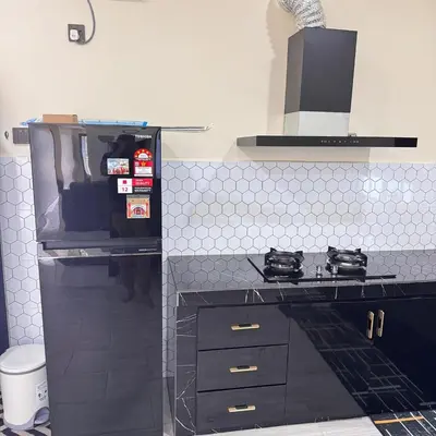 a kitchen with a stove and a stove top oven at Homestay D'Ammar Private Pool in Gua Sai