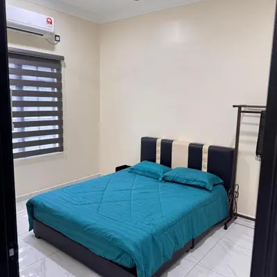 a bedroom with a bed with blue sheets and a window at Homestay D'Ammar Private Pool in Gua Sai