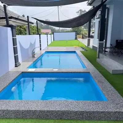 a swimming pool in the middle of a yard at Homestay D'Ammar Private Pool in Gua Sai