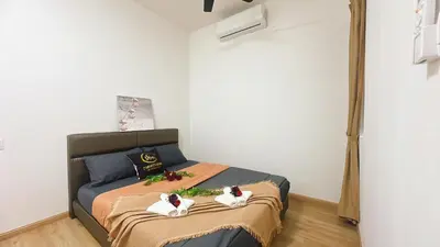 a bedroom with a bed with two dolls on it at A29 Ella Dato Onn 23 Max 10 People in Gua Sai