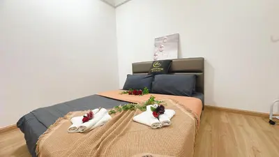 a bedroom with two beds with towels on them at A29 Ella Dato Onn 23 Max 10 People in Gua Sai