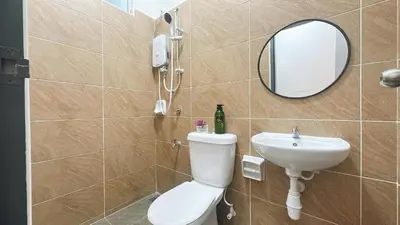 a bathroom with a toilet and a sink and a mirror at A29 Ella Dato Onn 23 Max 10 People in Gua Sai