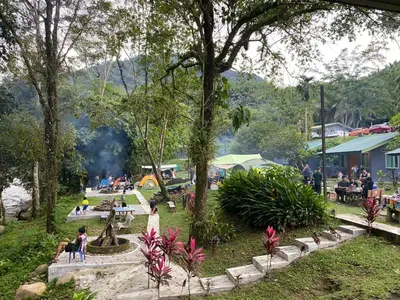 a group of people sitting around a park at Ulu River Lodge, Riverbug Perak in Gopeng