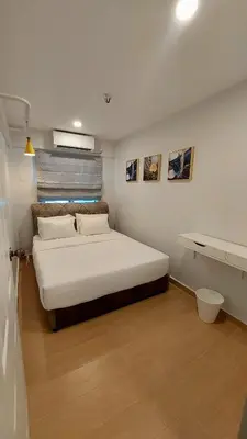 a bedroom with a large white bed in a room at The Minimalist Stay Station 18 in Ipoh