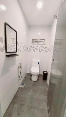 a bathroom with a toilet and a glass shower at The Minimalist Stay Station 18 in Ipoh