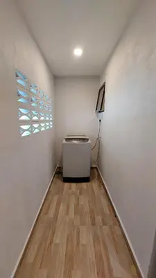 a room with a white wall and a window at The Minimalist Stay Station 18 in Ipoh