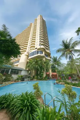 a large building with a swimming pool in front of it at Maisie Rainbow Penang in Tanjung Bungah