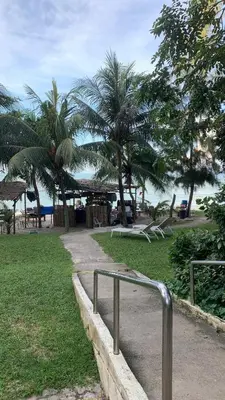 a park with palm trees and a playground at Maisie Rainbow Penang in Tanjung Bungah