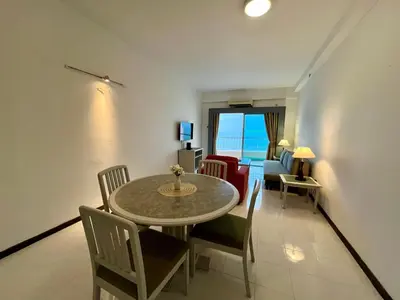 a living room with a table and chairs and a couch at Maisie Rainbow Penang in Tanjung Bungah