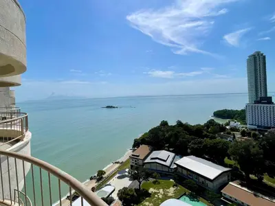 a view of the ocean from a balcony of a building at Maisie Rainbow Penang in Tanjung Bungah