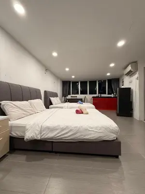 a large bed in a room with a kitchen at THE CEO 3 BEDROOM near USM SPICE ARENA PANTAI SPECIALIST AIRPORT in Bayan Lepas