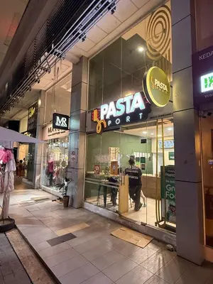 a pizza store with a man standing in the window at THE CEO 3 BEDROOM near USM SPICE ARENA PANTAI SPECIALIST AIRPORT in Bayan Lepas