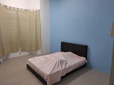 a bedroom with a bed in a room with a window at BC homestay at Alma Indah in Bukit Mertajam