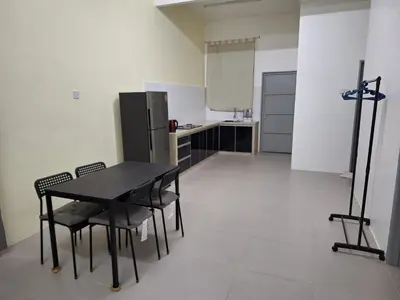 a kitchen with a table and chairs and a refrigerator at BC homestay at Alma Indah in Bukit Mertajam