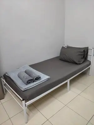 a bench with two towels and a bag on it at Pa&Ma HomeStay Kulim III 3R2B FullyAircond in Gua Sai