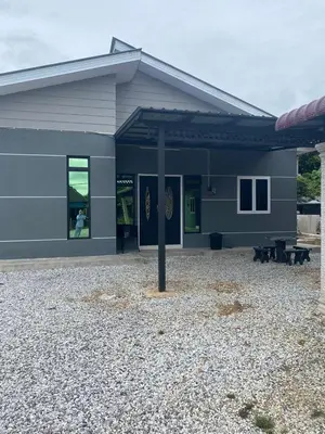 a gray building with a pole in front of it at AISY Homestay MERAPOH in Pulai