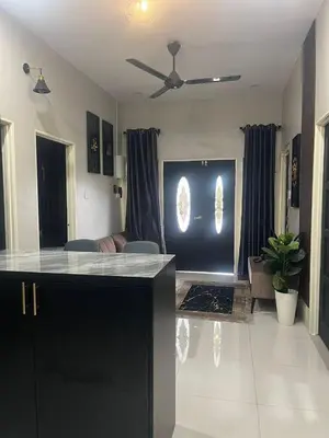 a kitchen and living room with a ceiling fan at AISY Homestay MERAPOH in Pulai